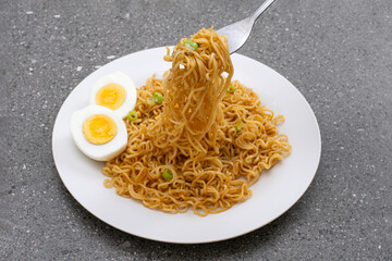 Fried instant noodles with boiled eggs