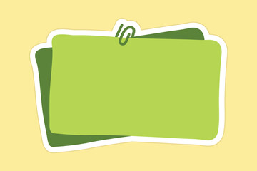 Green Sticky Note with Paperclip on Yellow