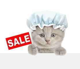 Funny tiny kitten wearing shower cat shows signboard with labeled 