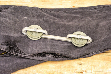 Metal clothesline spreader on a pair of jeans room for text