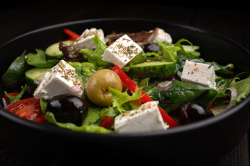 Classic Greek salad on dark background