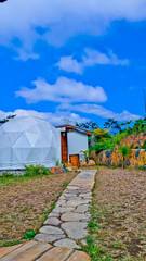 glamping tent view with blue sky background
