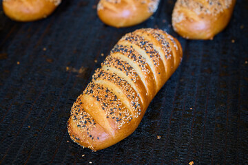 Freshly baked bread rolls golden brown and crusty from the bakery oven ready for cooling and...