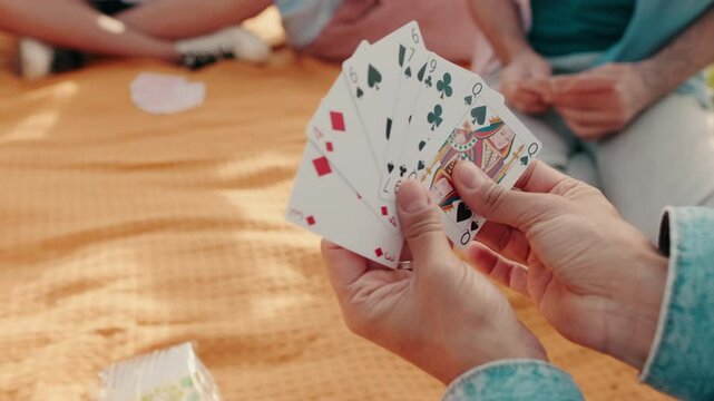 Friends Playing Cards At a Picnic