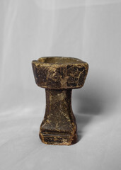 Ancient Handcrafted Ritual Oil Lamp or Incense Holder with Engraved Patterns on Light Background