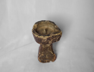 Ancient Handcrafted Ritual Oil Lamp or Incense Holder with Engraved Patterns on Light Background