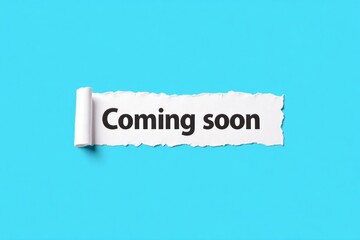 Ripped paper revealing the words "Coming soon".