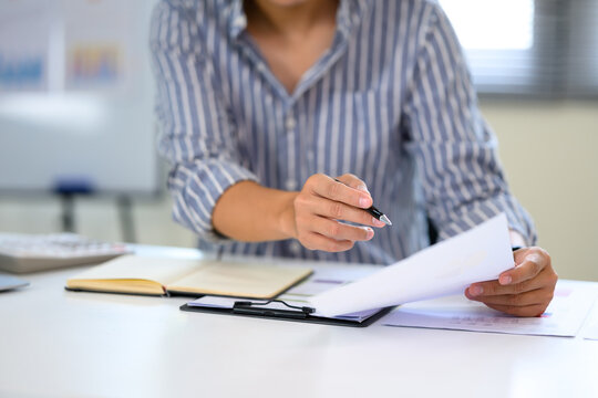 Businessman going through financial or business reports in a clean workspace