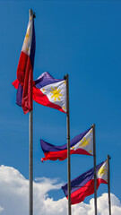 Philippine flags against bright blue sky