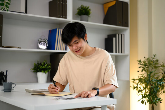 Adult asian man reviewing expenses and calculating monthly home budget