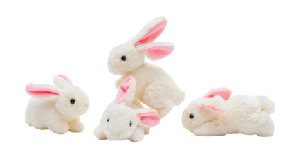 Four fluffy white toy rabbits with pink ears arranged on a black background isolated on a transparent background