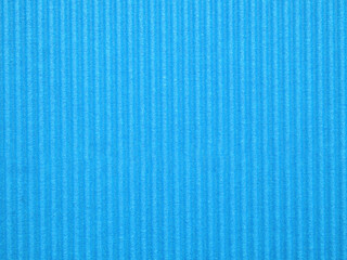 Obraz premium Top view, blank textured, vibrant blue corrugated cardboard surface. The distinct parallel ridges and grooves run vertically across the frame. Concept for design, image, text, and banner.