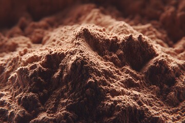 A close-up view of a pile of cocoa powder, revealing the textured surface