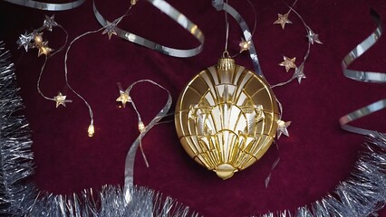 Elegant Christmas Ornament with Star Lights and Silver Tinsel on a Burgundy Background