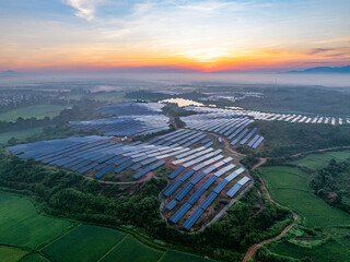 Photovoltaic panels on a hillside at sunrise