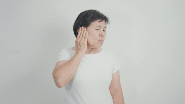 Elderly Woman having Ear pain for concept of Ear disease, Atresia, Otitis Media, Infection, Pertorated Eardrum, Meniere syndrome, Otolaryngologist, Hearing Loss, Hyperacusis, Tinnitus and Earwax