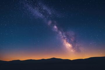 Milky Way galaxy shining brightly over dark mountain silhouette at sunset sky