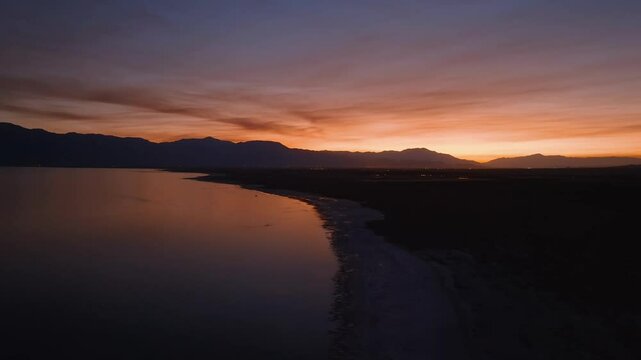 Aerial view of a dramatic glowing sky over the Salton Sea with smokey clouds from wildfires.