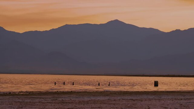 Aerial view of a dramatic glowing sky over the Salton Sea with smokey clouds from wildfires.