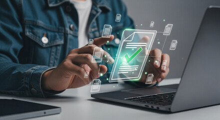 Person using laptop with digital documents and a green checkmark overlaying the screen interface