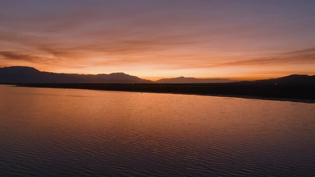 Aerial view of a dramatic glowing sky over the Salton Sea with smokey clouds from wildfires.