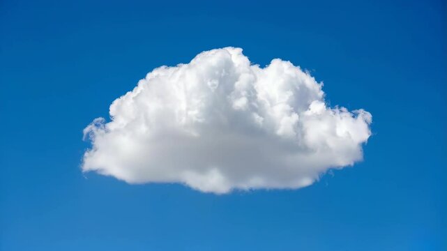 Single white fluffy cloud floats in a bright blue sky on a sunny day, puffy isolated cloud formation. Beautiful summer weather backdrop.