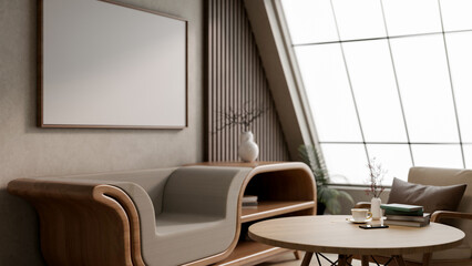 Blank frame hanging over a multifunctional wooden armchair and round table in an attic living room.