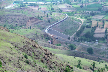 Passenger train hauled by a WAP7 electric locomotive near Pune India.