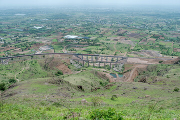 Passenger train hauled by a WAP7 electric locomotive near Pune India.