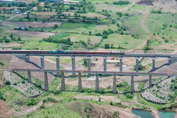 Passenger train hauled by a WAP7 electric locomotive near Pune India.