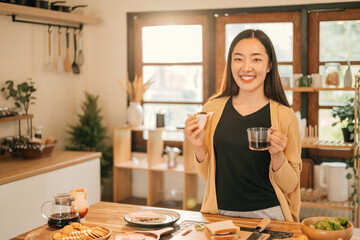 Happy Asian Woman Enjoying Coffee and Sandwich, Homemade Breakfast Moment Concept