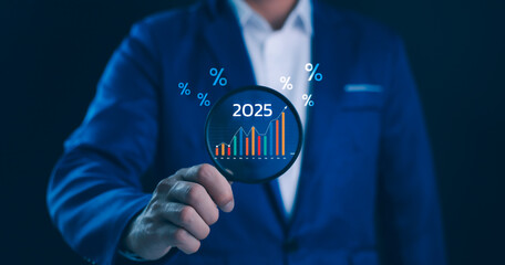 Business Growth and Financial Forecast 2025 Concept. A person uses a magnifying to examine economic data and trends for the year 2025, percentage symbols, market analysis and strategic planning.