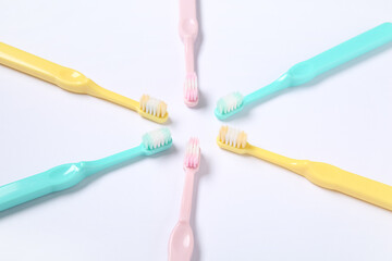 Colorful plastic toothbrushes on white background.