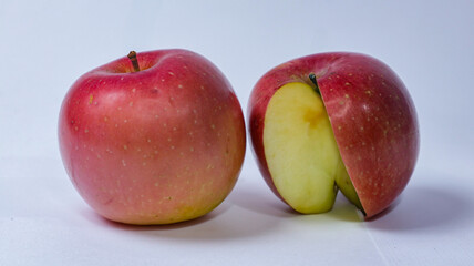 Half apple with red apple isolated. Apple on white background. Red apple with clipping path. Full depth of field. High quality photo without editing