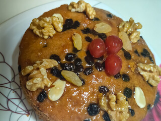 Chocolate Home made cake with dried fruit, raisins, cashew nuts, almond etc. Tasty homemade cake flavored with cinnamon and spices for sale on Christmas and new year