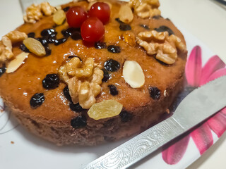 Chocolate Home made cake with dried fruit, raisins, cashew nuts, almond etc. Tasty homemade cake flavored with cinnamon and spices for sale on Christmas and new year