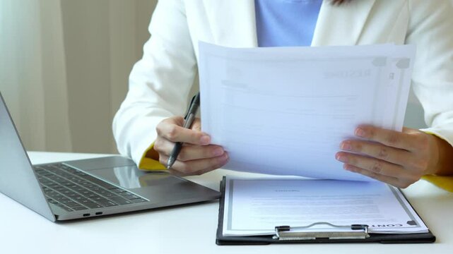 Business woman employer holding resume hiring recruit looking cv resume to hire candidates, analyzing information before job interview. Recruitment concepts.