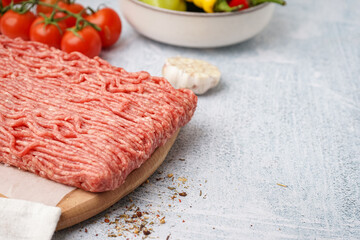 Wooden board of fresh minced meat on white background