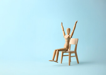 Wooden Mannequin Sitting and Stretching Arms Up – Symbol of Morning Routine, Relaxation, and Flexibility