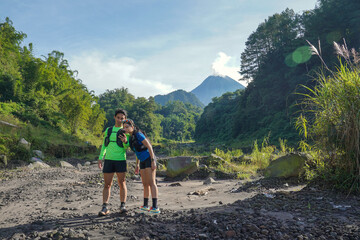Asian Couple Looking at Phone During Trail Run in Tropical Nature