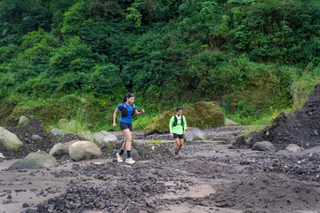 Asian Indonesian couple trail running outdoors, active sustainable lifestyle exercise