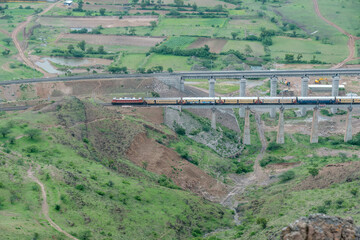 Passenger train hauled by a WAP4 electric locomotive near Pune India.