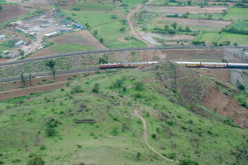 Passenger train hauled by a WAP4 electric locomotive near Pune India.