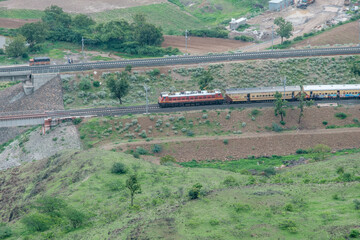 Passenger train hauled by a WAP4 electric locomotive near Pune India.