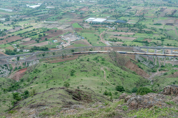 Passenger train hauled by a WAP4 electric locomotive near Pune India.