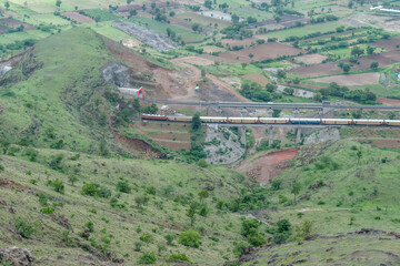Passenger train hauled by a WAP4 electric locomotive near Pune India.