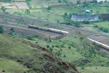 Passenger train hauled by a WAP4 electric locomotive near Pune India.