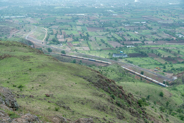 Passenger train hauled by a WAP4 electric locomotive near Pune India.