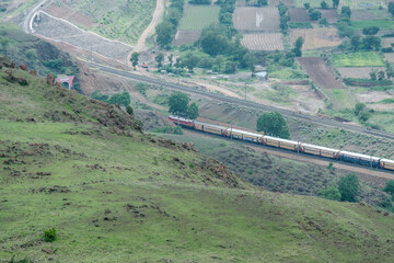 Passenger train hauled by a WAP4 electric locomotive near Pune India.