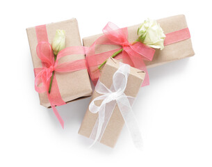 Gift boxes with beautiful roses on white background. International Women's Day